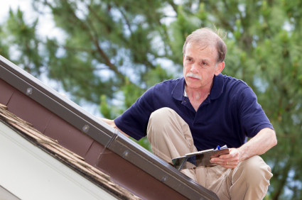 An inspector on the roof examines a skylight
